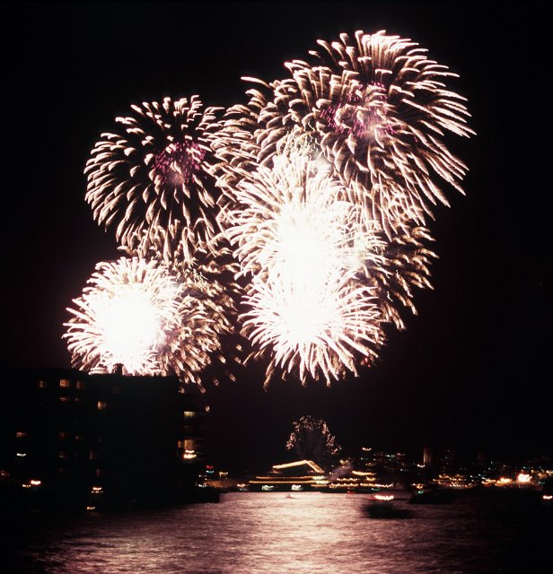 blurred fireworks refecting over water