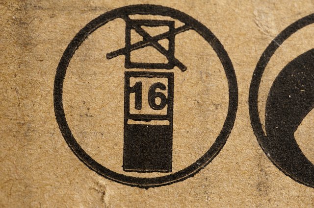 A brown cardboard box with stacking height symbols on it