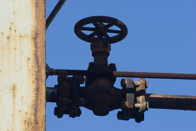 rusted stopcock contrasted against a blue sky