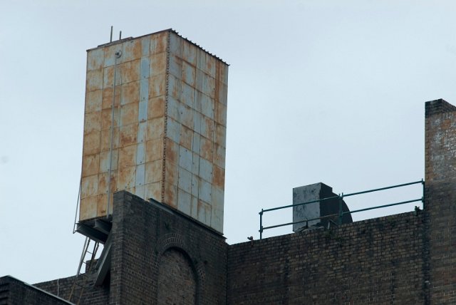 a rusty old rooftop water tank