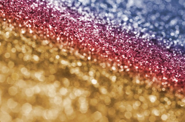 Full Frame Abstract Celebratory Background of Sparkling Multi-Colored Glitter Framed on Angle in Shallow Depth of Field with Copy Space and Selective Focus