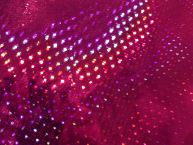 colorful specturm of light reflecting from a pink coloured surface