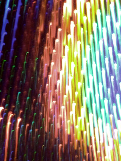 motion blurred lguht trails creating a falling effect in multiple gradated colours