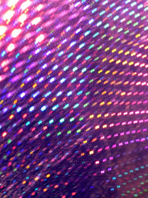 a purple coloured relfective background iridescent colour created by microfacets