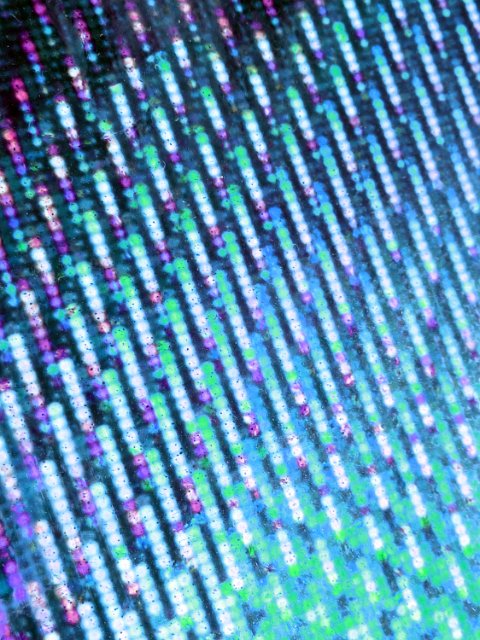 a green and purple tinted metallic foil background