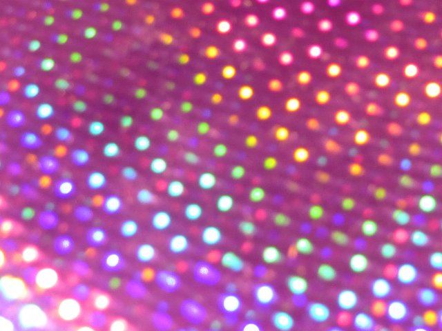 a purple background with diffuse colorful highlights formed into a matrix pattern