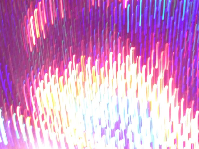 bright burnt out light lines with a motion blur in predominantly red and purple hues