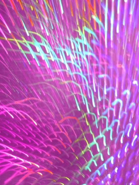 abstract curved motion blurs formed with a spectrum of coloured lights