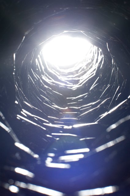 brilliant white blue light shining down a silvered flexible duct