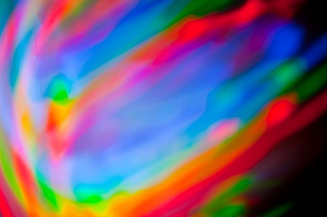 a creative background of mixing red green and blue vivid coloured strokes of light