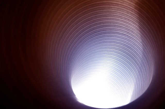 light at the end of a blue pink tinted metal tube