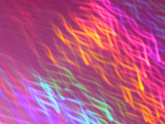 waves of light falling diagonally creating an diffuse colorful background