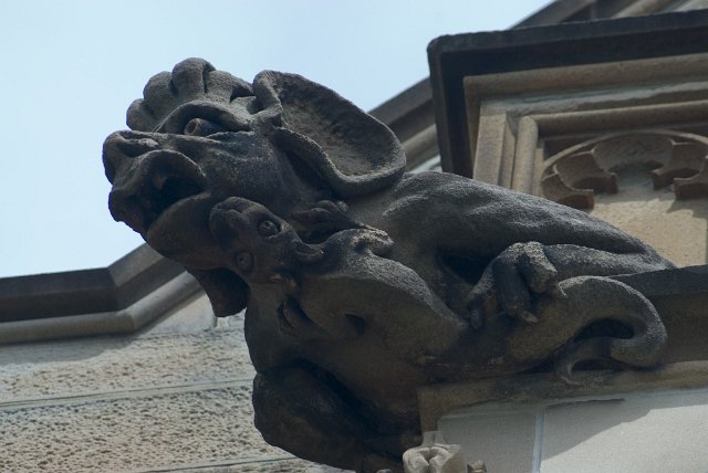 stone scuplture with baby stone sculpture clinging on below