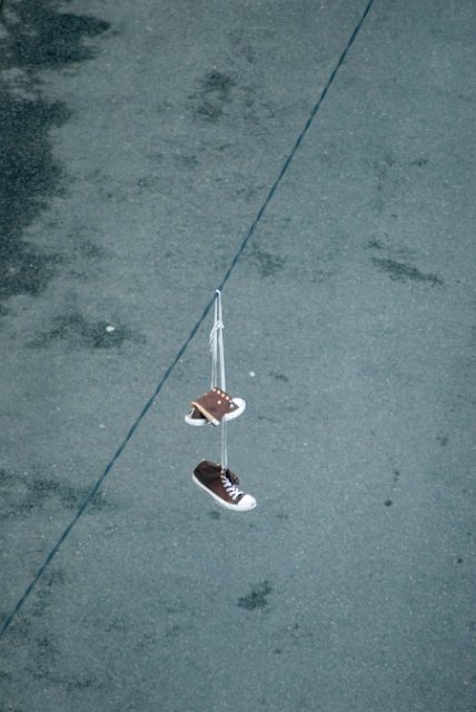 sneakers hanging on a power cable