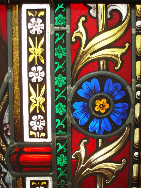 close up on a freeze around a stained glass window