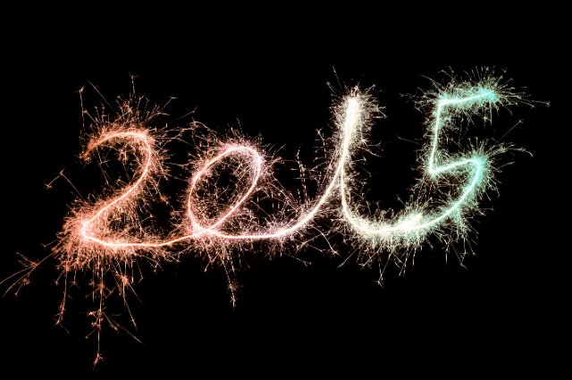 sparkling trails of light drawing out the numbers 2015 in glowing light to welcome in the new year