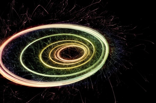 bright sparks plotting a colorful spiral pattern