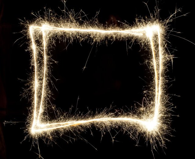a rectangular frame of glowing sparks