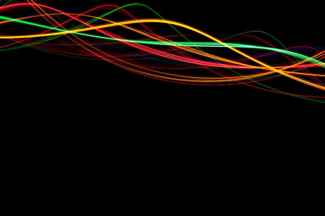 colorful background of sunusoidal trails of light