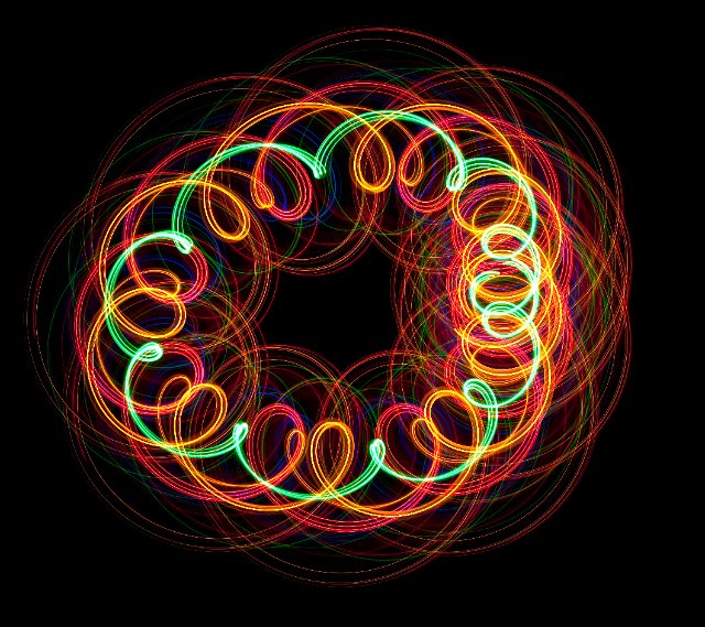 red green and orange lights spiraling round to form a circular pattern