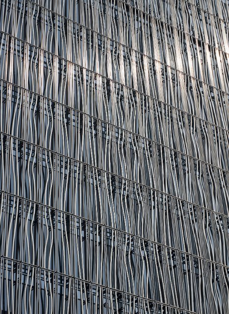 A close up detailed shot of a metallic, metal building grill.