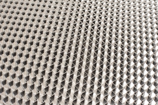 Full frame background texture of the grid or grate of a metal filter in an industrial concept