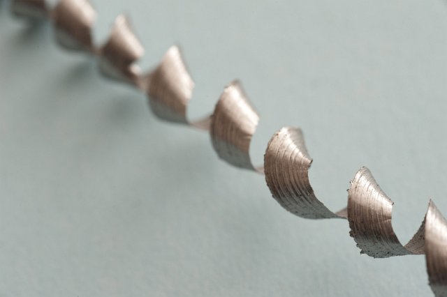 Spirally coiled metal swarf or shaving produced during machining and production in an industry concept