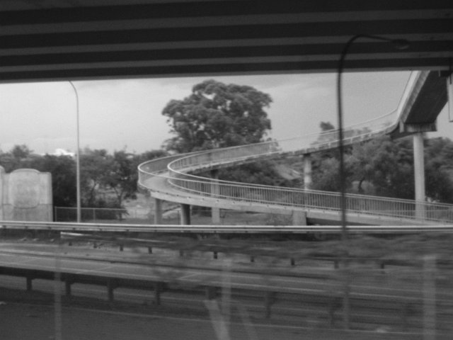 monochrome blurred view of a concete pedestrian walkway