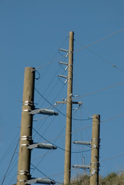three power poles with cables between