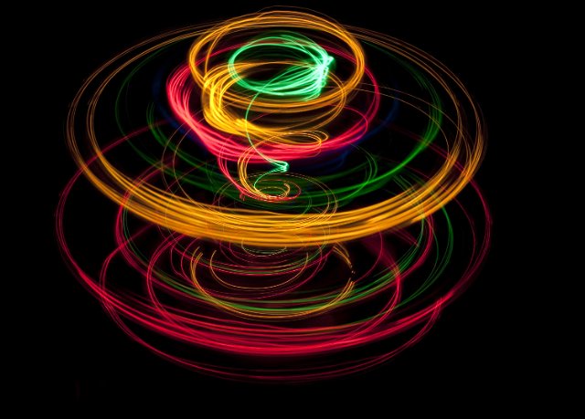 glowing lines of light plotting a spiraling circular pattern