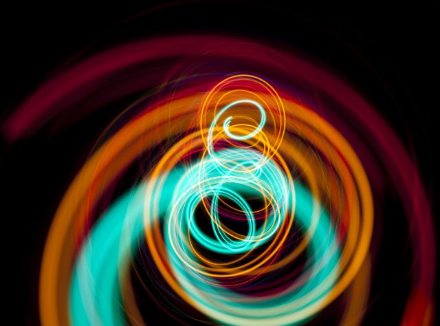 thick and thin colorful light lines plotting spiraling patterns