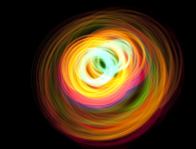 multiple overlapping circles of glowing light creating an abstract pattern