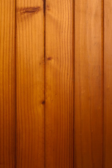 Background of laminated wooden planks in tongue and groove formation with wood grain used as a building material