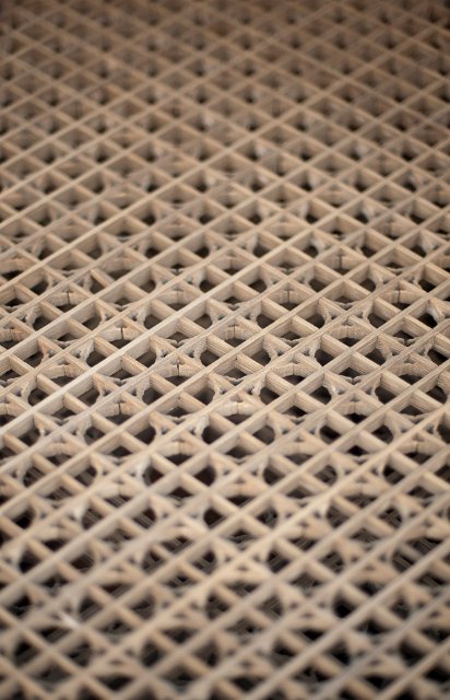 Wooden lattice with a diamond pattern viewed from a high angle with shallow dof on a receding perspective