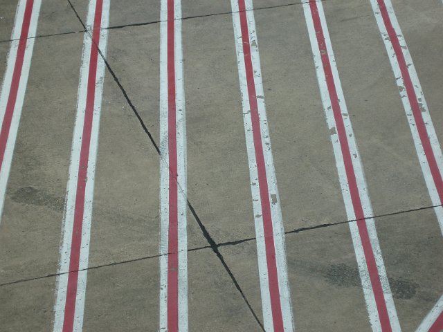red and white stripes on an airport apron