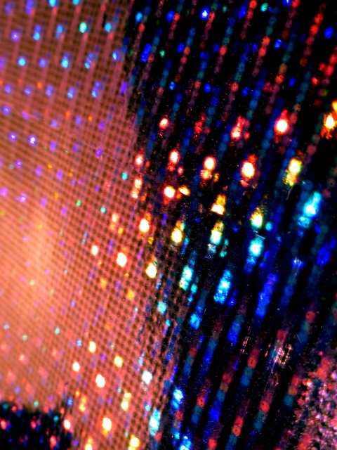 colorful light created through reflections from a layer of holographic foil