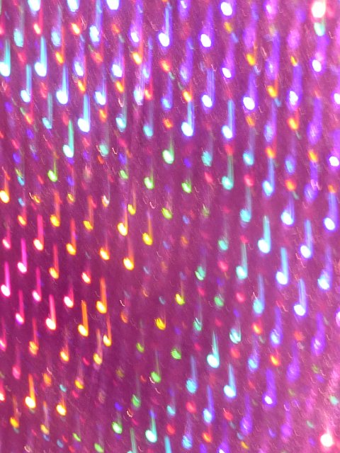purple background with light highlights blurred into the shape of crotchet music notes