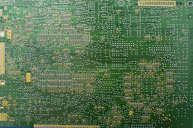 Printed electronic circuit backdrop on green in a full frame view from above