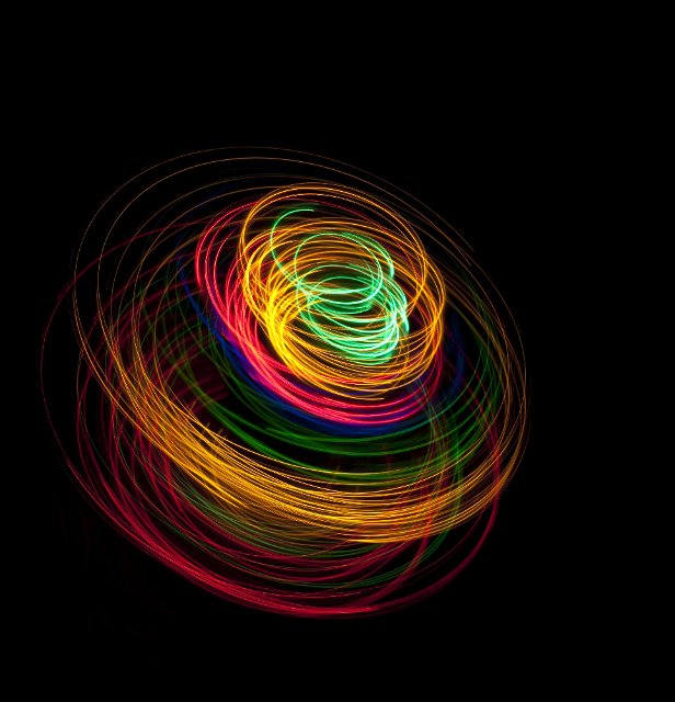 colorful light traces creating a 3d rotating effect