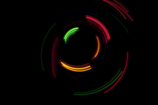 curved arcs of red, yellow, and green light formed around a central point
