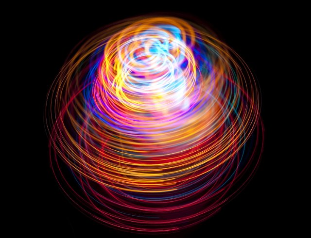 glowing colored light trails creating abstract forms and shapes