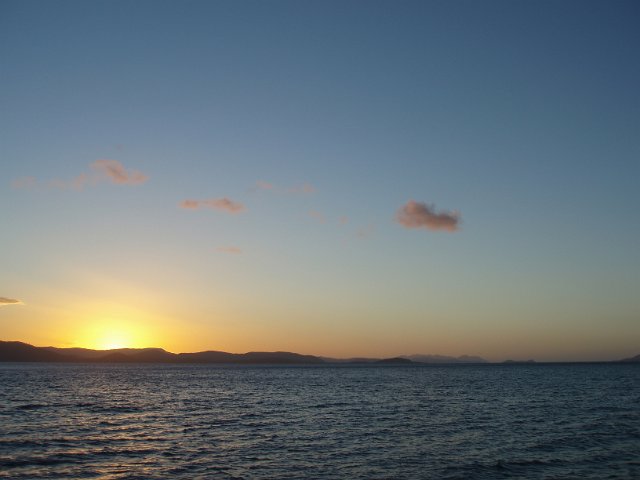 sunset sky over a distant landscape across the water